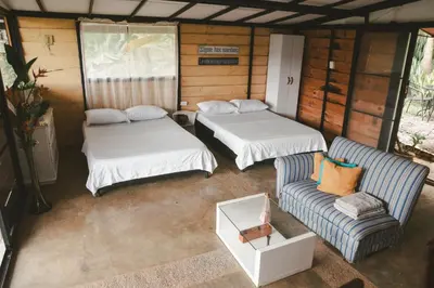 a room with two beds and a couch at Cabaña entre las montañas Tierra Mia - Eje Cafetero in Manizales