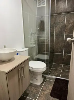 a bathroom with a toilet and a sink and a shower at Urban 102 in Manizales