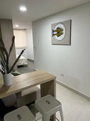 a room with a table and a plant and a picture at Urban 102 in Manizales