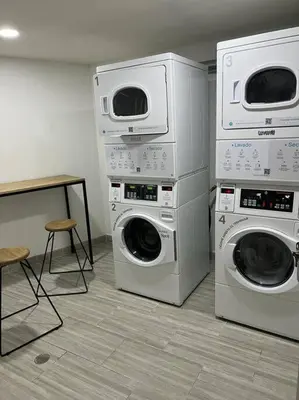 a room with two washing machines and a table at Urban 102 in Manizales