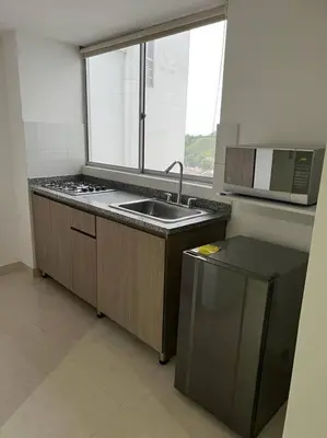 a small kitchen with a sink and a window at Urban 102 in Manizales