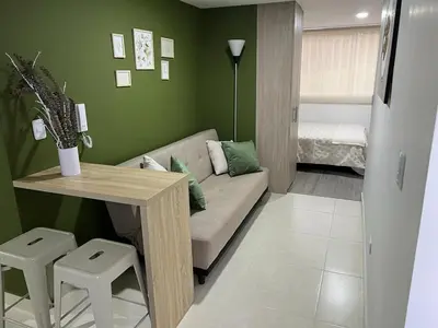 a living room with a couch and a table at Urban 102 in Manizales