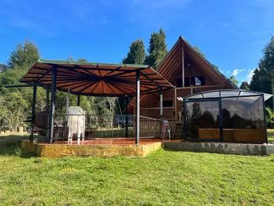 a pavilion in front of a house at chalets A-MAR By la malcriada in Guarne