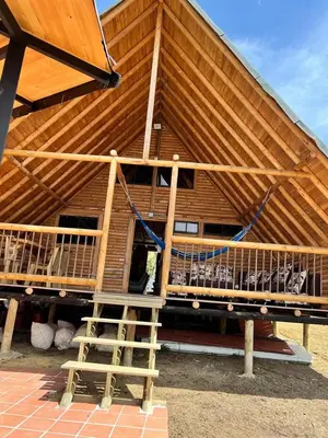 a large wooden house with a large roof at chalets A-MAR By la malcriada in Guarne