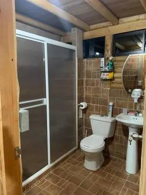 a bathroom with a shower and a toilet and a sink at chalets A-MAR By la malcriada in Guarne