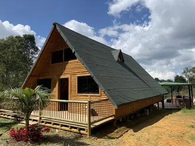 a log cabin with a gambrel roof at chalets A-MAR By la malcriada in Guarne