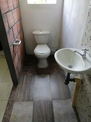 a bathroom with a toilet and a sink at Casa de relajación low cost in La Dorada