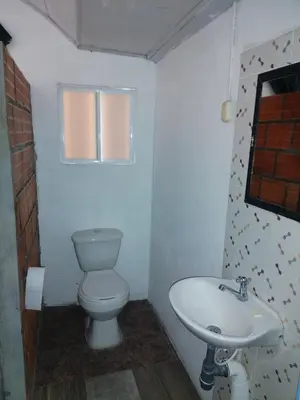 a bathroom with a toilet and a sink at Casa de relajación low cost in La Dorada