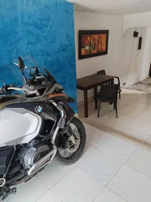 a motorcycle parked in a room with a table at Casa de relajación low cost in La Dorada