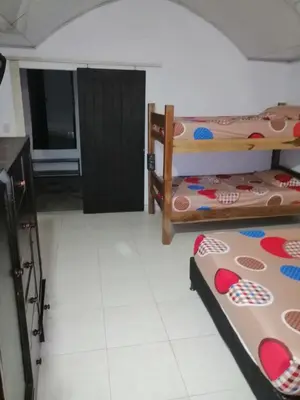 a room with two bunk beds and a door at Casa de relajación low cost in La Dorada
