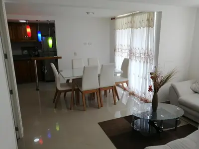 a living room with a table and chairs and a couch at Lindo Apartamento para estadía familiar in Rionegro