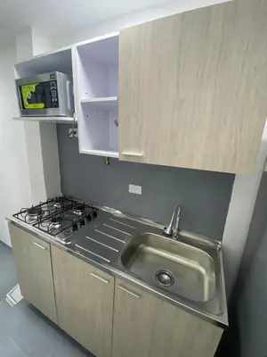 a kitchen with a sink and a stove at apartamento en Medellin, Santa Monica in Medellín