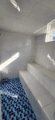 a empty room with white walls and blue tiles at Apartasol Club Ciudadela Santa Fe - Santa Fe de Antioquia in Santa Fe de Antioquia