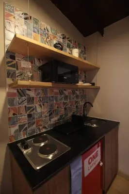 a kitchen with a sink and a counter top at Apartamento con parqueadero en Medellín -ONE201 By Roots Rentals in Medellín