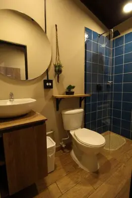 a bathroom with a toilet and a sink and a shower at Apartamento con parqueadero en Medellín -ONE201 By Roots Rentals in Medellín
