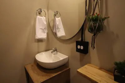 a bathroom with a white sink and a mirror at Apartamento con parqueadero en Medellín -ONE201 By Roots Rentals in Medellín