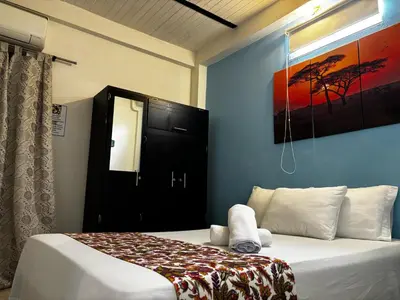 a bedroom with a bed with a black door and a painting at cabaña82 in Puerto Triunfo