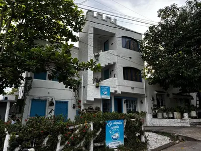 a white building with a sign in front of it at cabaña82 in Puerto Triunfo