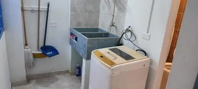 a small kitchen with a sink and a washing machine at cabaña82 in Puerto Triunfo