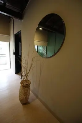 a vase on the floor with a mirror on a wall at Apartamento cerca Unidad Deportiva Belén - ONE202 By Roots Rentals in Medellín