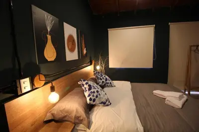 a bedroom with a bed with two pillows on it at Apartamento cerca Unidad Deportiva Belén - ONE202 By Roots Rentals in Medellín
