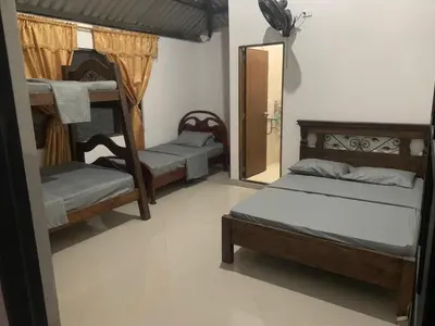 a room with three bunk beds and a mirror at QUINTA CAMPESTRE LA FLORIDA in Mariquita