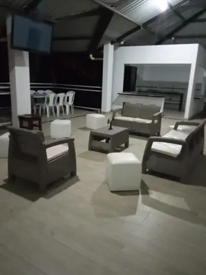 a living room with couches and a table and chairs at QUINTA CAMPESTRE LA FLORIDA in Mariquita