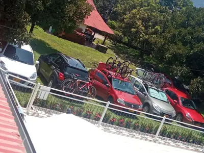 a group of cars parked in a parking lot with bikes on them at QUINTA CAMPESTRE LA FLORIDA in Mariquita