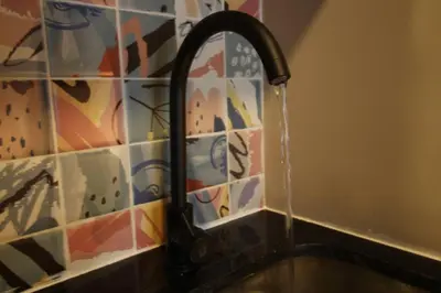 a kitchen sink with water running from a faucet at Apartamento Centro Comercial los Molinos - ONE203 By Roots Rentals in Medellín
