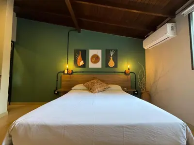 a bedroom with a large white bed with two lights at Apartamento Centro Comercial los Molinos - ONE203 By Roots Rentals in Medellín