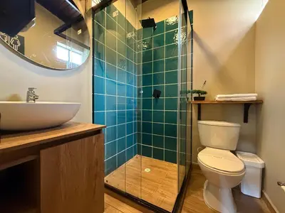 a bathroom with a sink and a toilet and a shower at Apartamento Centro Comercial los Molinos - ONE203 By Roots Rentals in Medellín