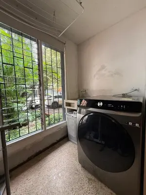a kitchen with a stove and a large window at Apartamento Centro Comercial los Molinos - ONE203 By Roots Rentals in Medellín