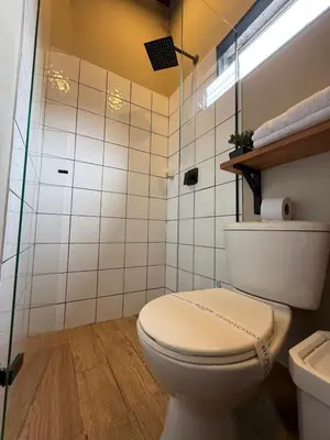 a bathroom with a white toilet and a shower at Apartamento cerca a clínica las Américas - ONE204 By Roots Rentals in Medellín