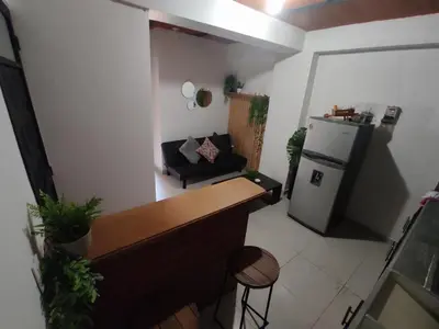 a small kitchen with a refrigerator and a couch at Alejandría 1 in Itagüí