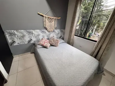 a small bed in a room with a window at Alejandría 1 in Itagüí