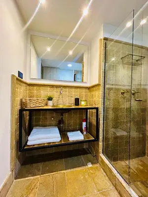 a bathroom with a shower and a sink and a mirror at Modern, Apt/near tourist sites. in Medellín