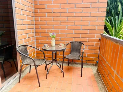 a small table and two chairs on a patio at Modern, Apt/near tourist sites. in Medellín