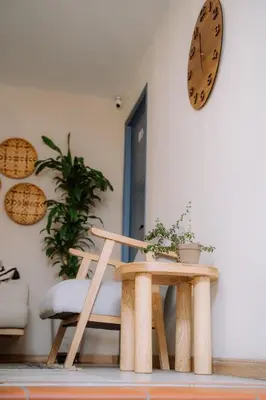 a room with a table and a clock on the wall at Poblado Luum Boutique hotel in Medellín