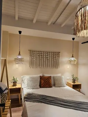 a bedroom with a bed with two tables and two lights at Poblado Luum Boutique hotel in Medellín