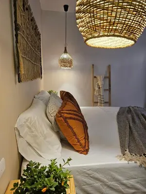 a bedroom with a bed with pillows on it at Poblado Luum Boutique hotel in Medellín