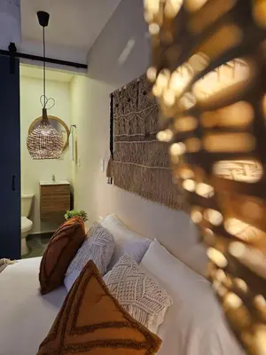 a bedroom with a bed with two pillows on it at Poblado Luum Boutique hotel in Medellín
