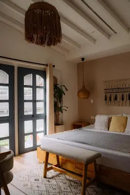 a bedroom with a bed and a large window at Poblado Luum Boutique hotel in Medellín
