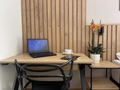 a laptop computer sitting on a wooden desk at Vita Hotel Boutique - Aire Acondicionado & Desayuno in Medellín