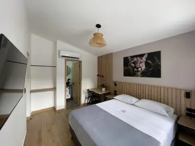 a bedroom with a large white bed and a desk at Vita Hotel Boutique - Aire Acondicionado & Desayuno in Medellín