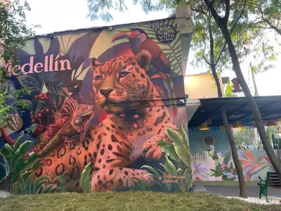a mural of a leopard and birds on the side of a building at Vita Hotel Boutique - Aire Acondicionado & Desayuno in Medellín