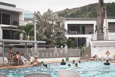 a group of people in a swimming pool at Encantador Apartamento Ciudadela in Santa Fe de Antioquia