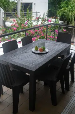a black table with chairs and a plate of fruit on it at Encantador Apartamento Ciudadela in Santa Fe de Antioquia