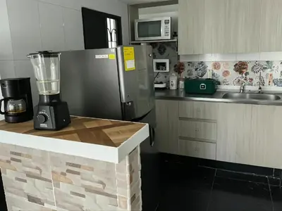 a kitchen with a blender on top of a counter at Aparta Suite Torre De Prado 501 in Medellín