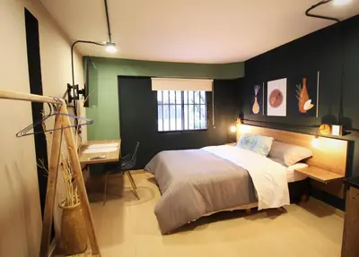 a bedroom with a bed and a desk and a window at Apartamento doble con baño privado y Wifi -ONE101 By Roots Rentals in Medellín