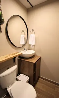 a bathroom with a white toilet and a mirror at Apartamento doble con baño privado y Wifi -ONE101 By Roots Rentals in Medellín